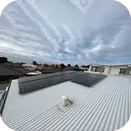 Solar panels installed on a commercial building roof, generating renewable energy