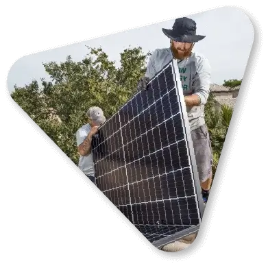 man installing solar panels on roof